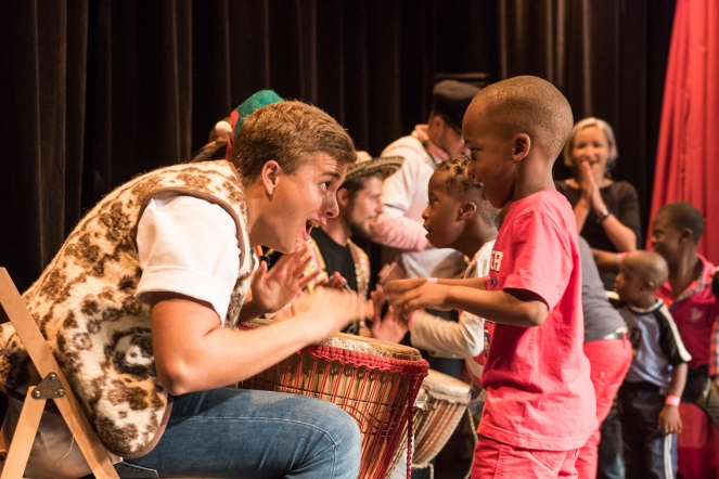 Kingston, Jamaica :: Timo Eschbach (Austria) and the percussion passion group interact with kids from Jamaica Down's Syndrome Foundation during a performance in the Hope Theatre.